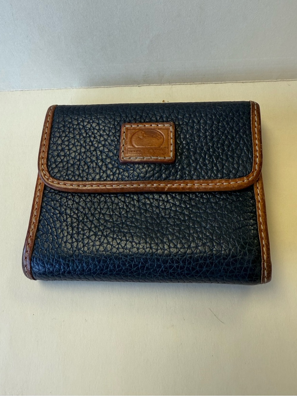 Dooney & Bourke Midnight Blue Pebbled Leather Bifold Wallet with Brown Trim